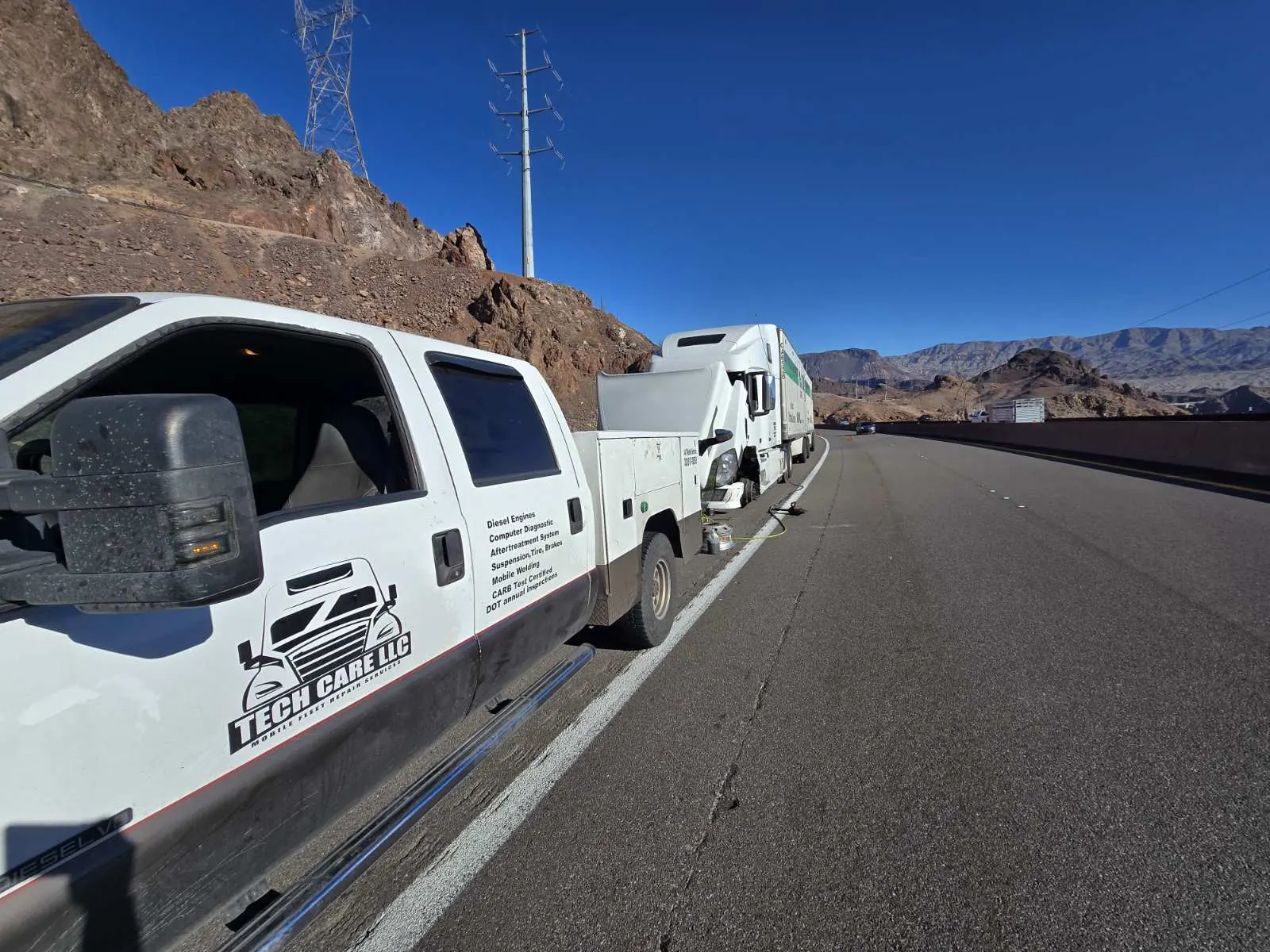 Tech Care service truck helping a broken-down semi on the highway near Las Vegas